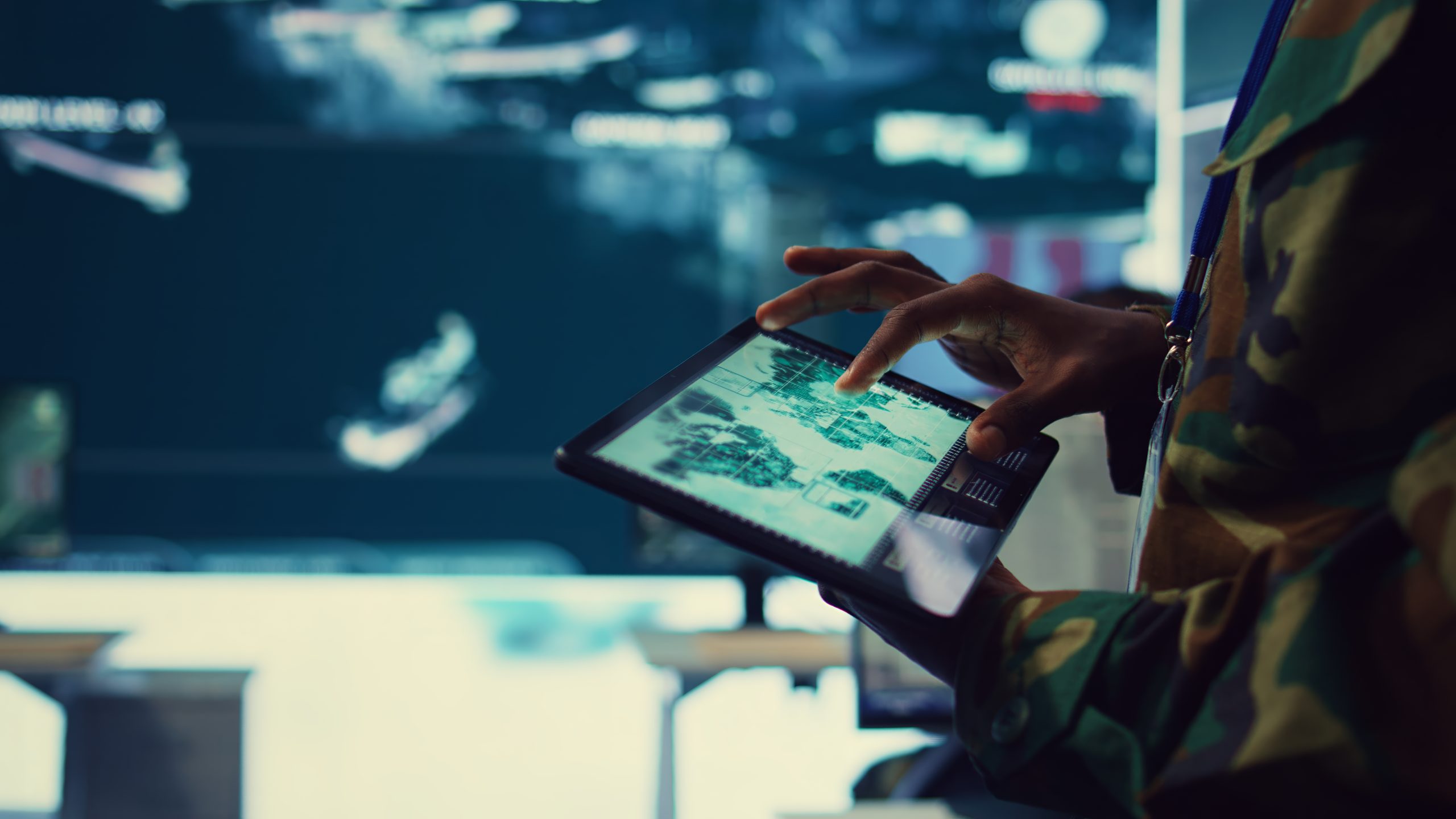 Army soldier reviews targets on satellite world map to ensure global protection
